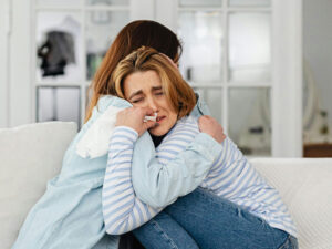 Adult consoling teen