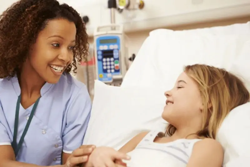 Nurse with young child in hospital